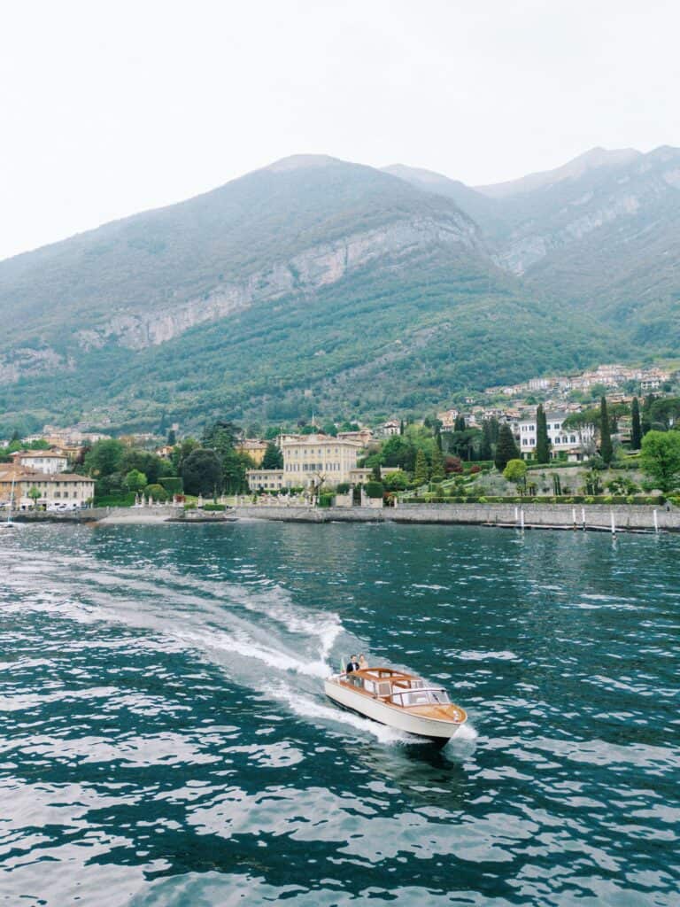 Bride and Groom on a boat with Villa Sola Cabiati background