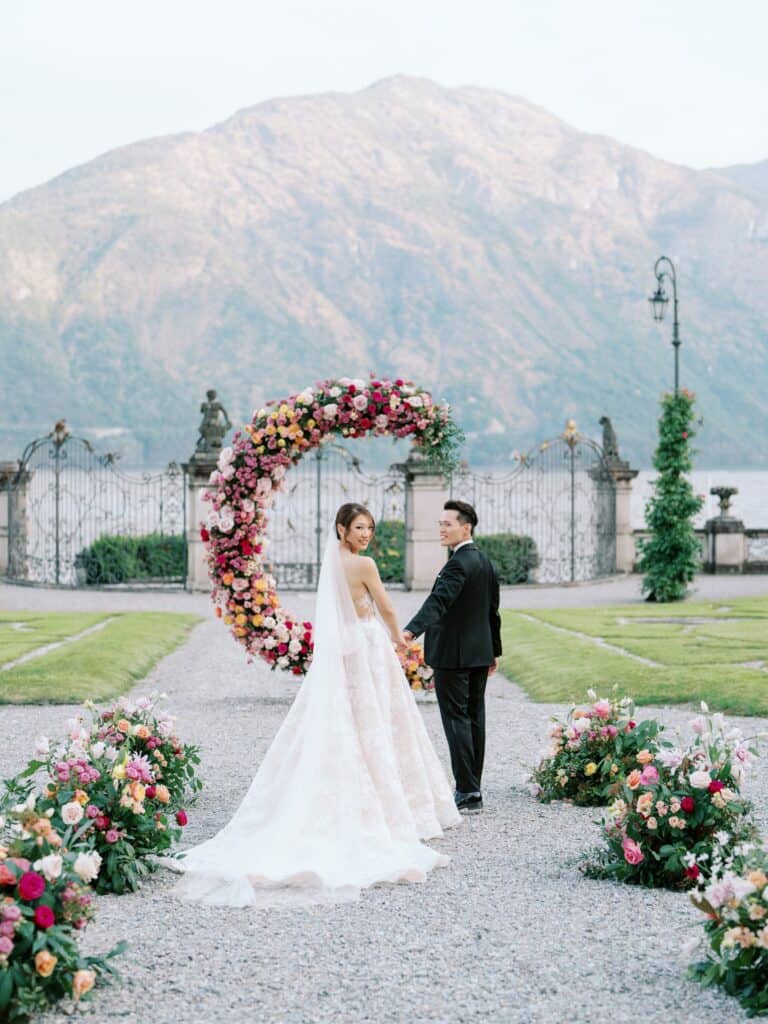 Bride and Groom posing in Villa Sola Cabiati gardens